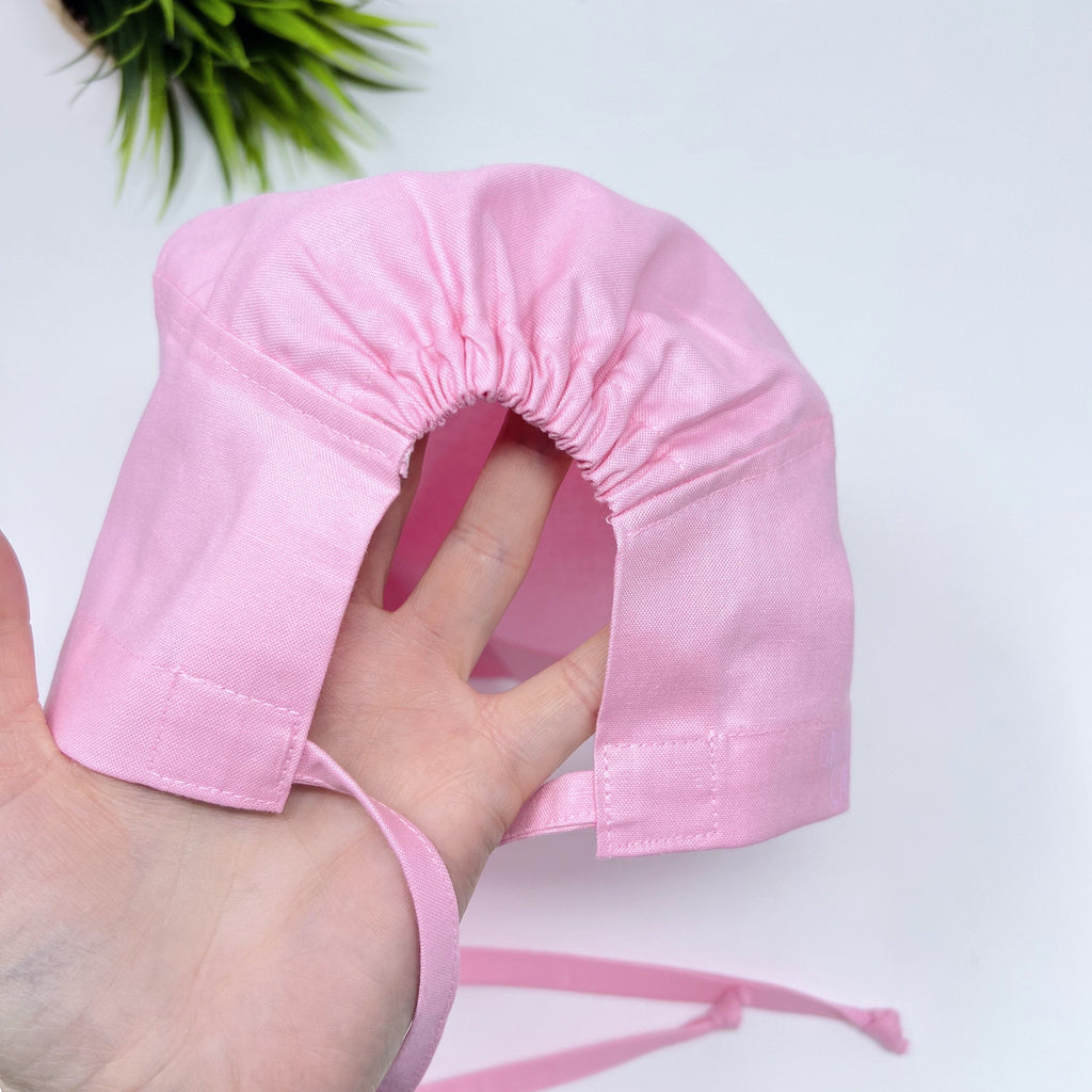 Solid pink Skull tie-back style surgical scrub cap for men by Paradise Caps.